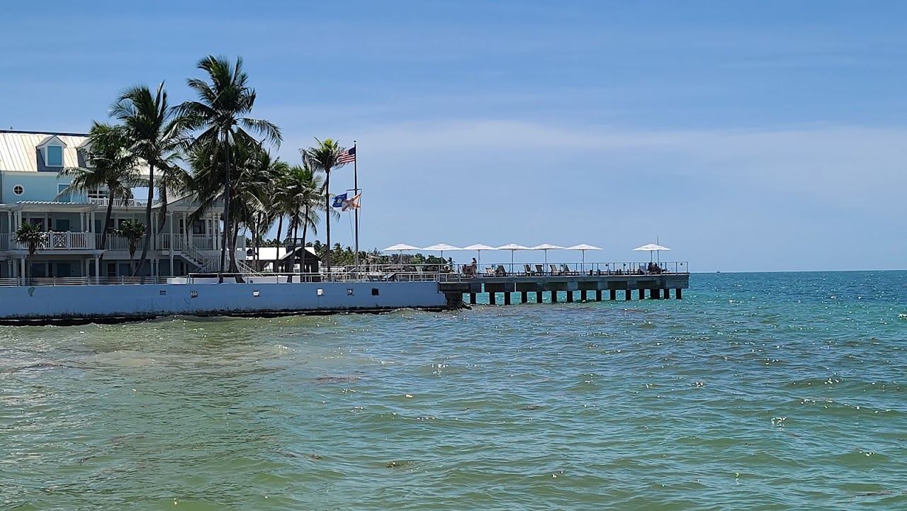 Small curve of sand and calm water at South Beach at the end of Duval Street in Key West