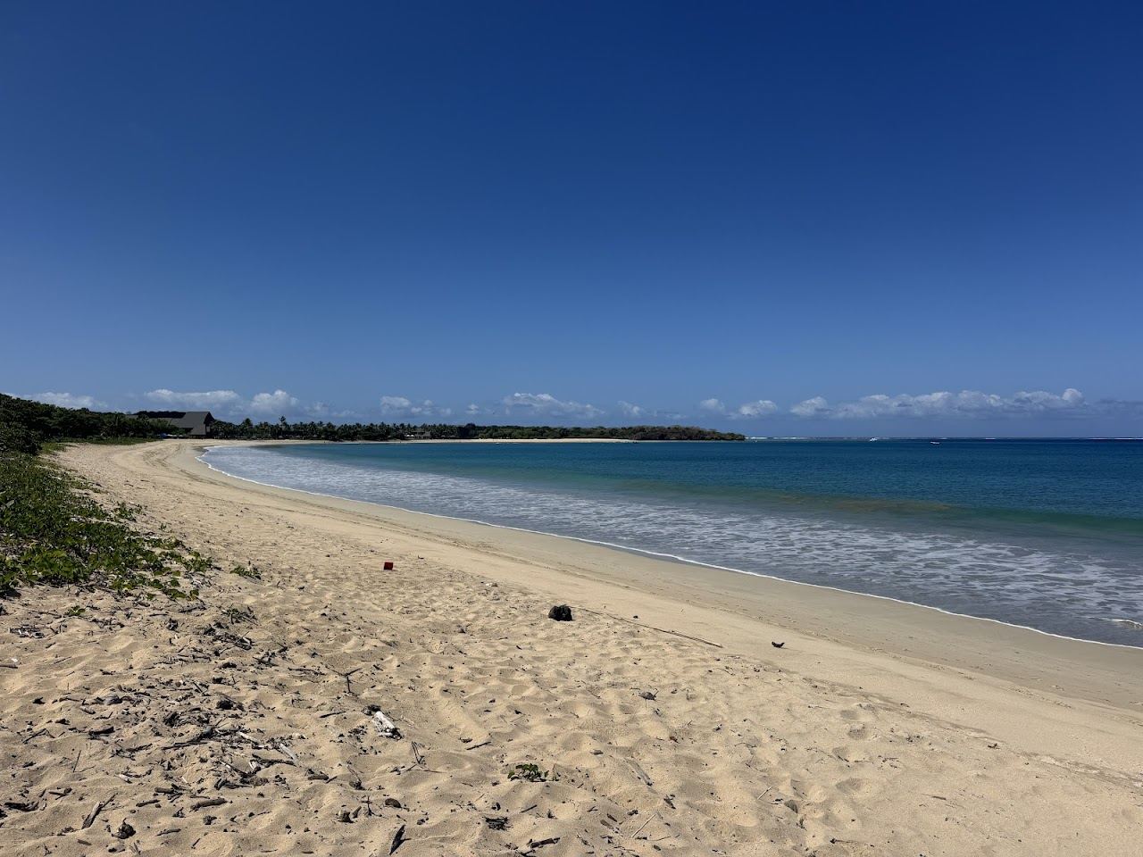 The wide golden sand and rolling surf of Natadola Beach on Viti Levu Fiji