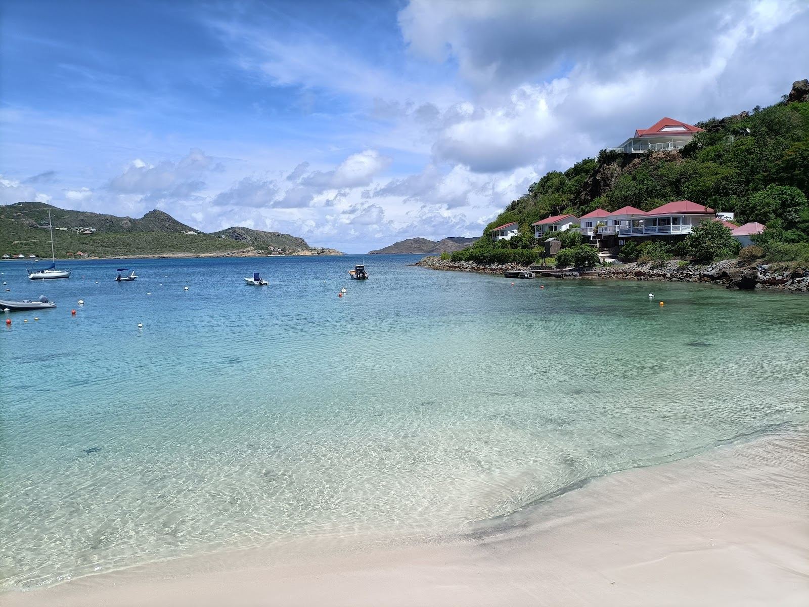The calm reef sheltered lagoon and pale sand of St Jean beach in St Barths