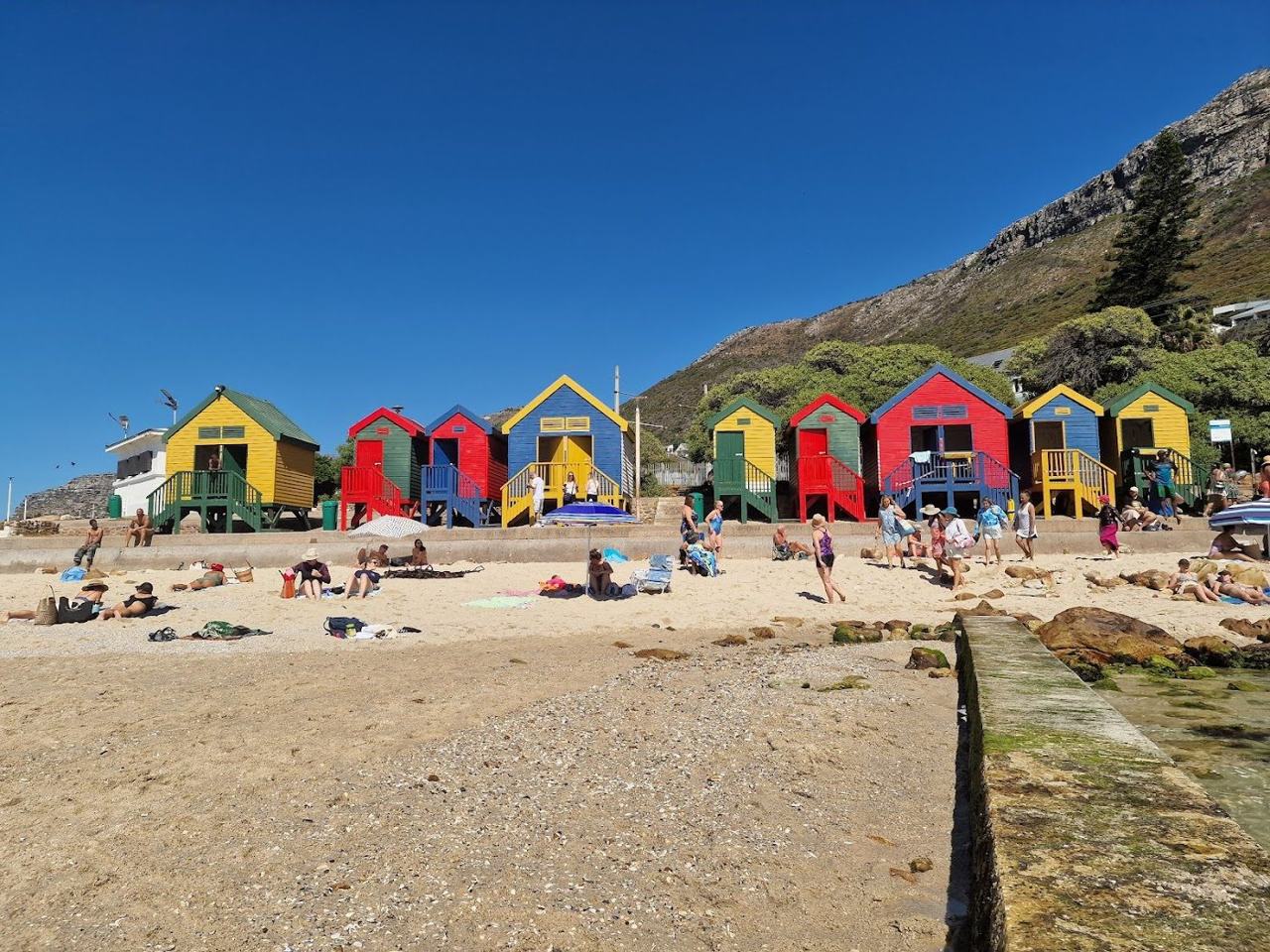 The colourful bathing boxes and tidal pool of St James on False Bay near Muizenberg in Cape Town