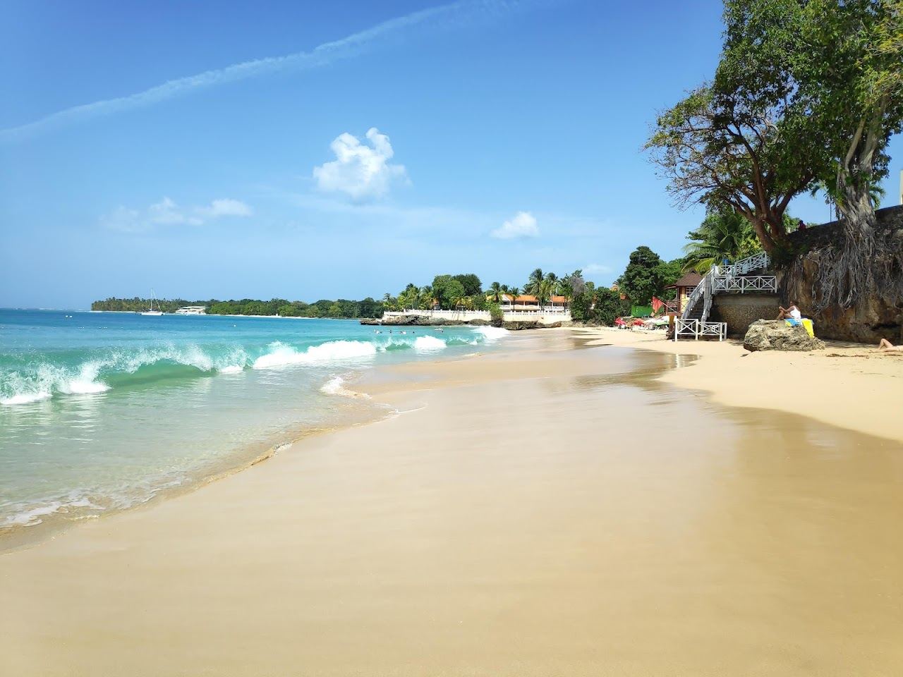 Pale sand and calm water at Store Bay near the airport in Tobago
