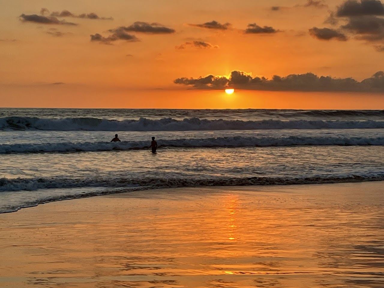 Golden hour sunset over the wide west facing sand of Playa Santa Teresa Costa Rica