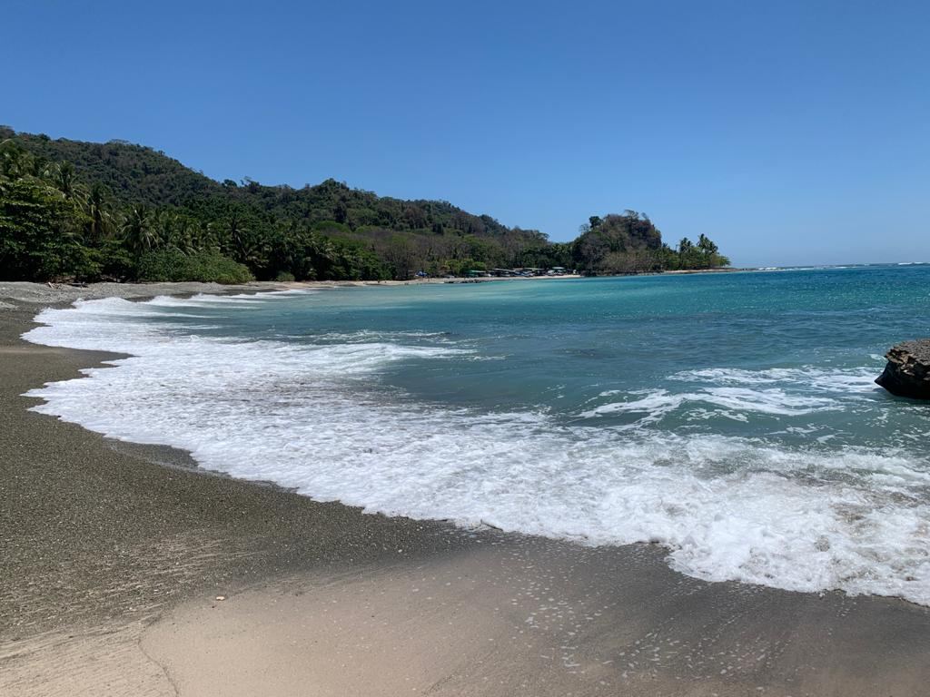 Wide pale gold sand and a mellow surf break at Playa Hermosa near Santa Teresa Costa Rica