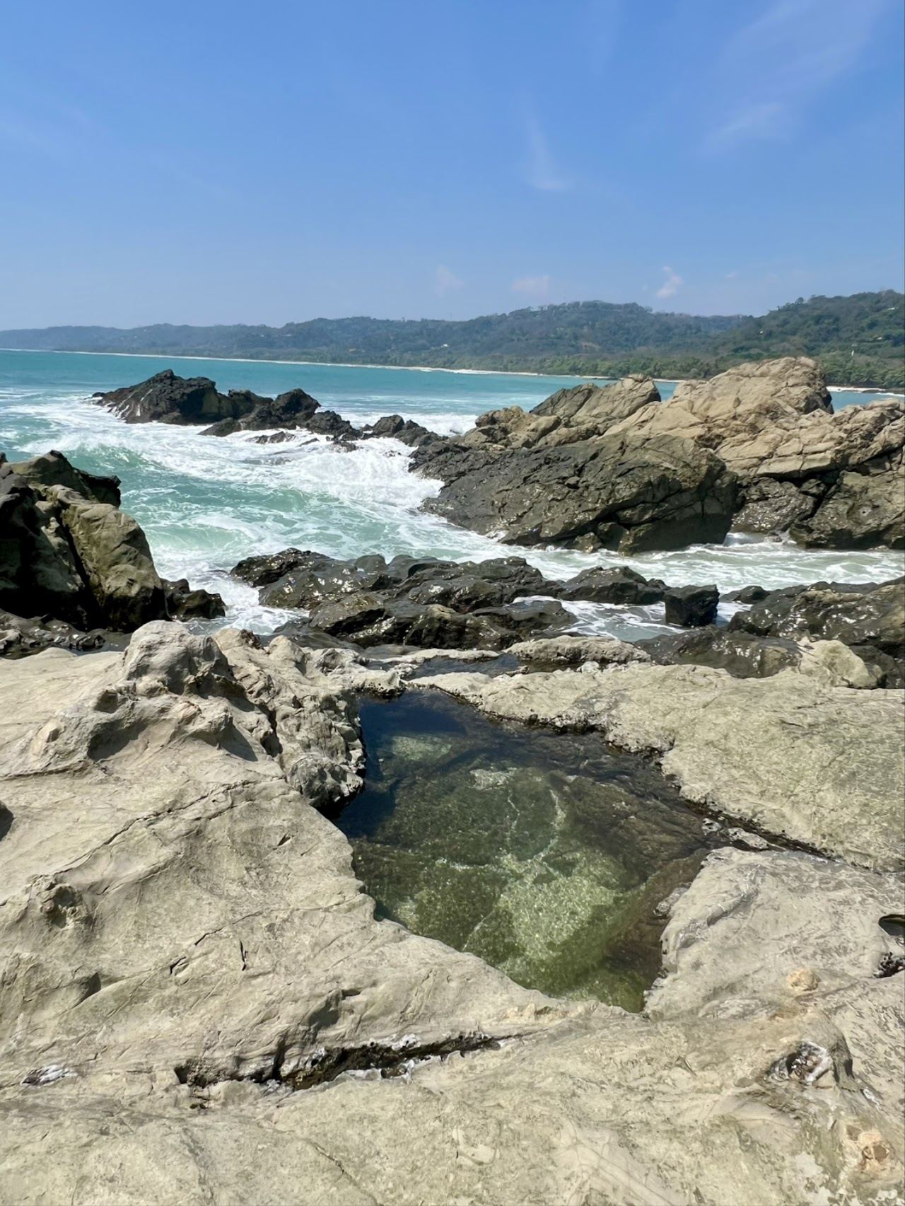 Surf and natural rock pools at Mar Azul beach in Mal Pais Costa Rica