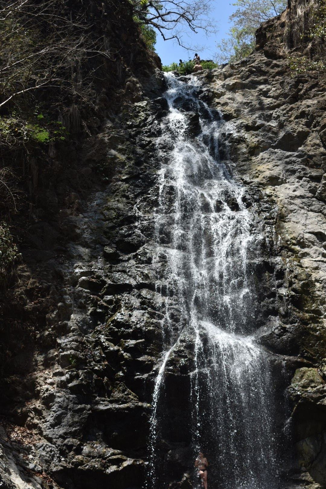 The stacked Montezuma waterfall dropping into a swimming pool in the Costa Rica jungle