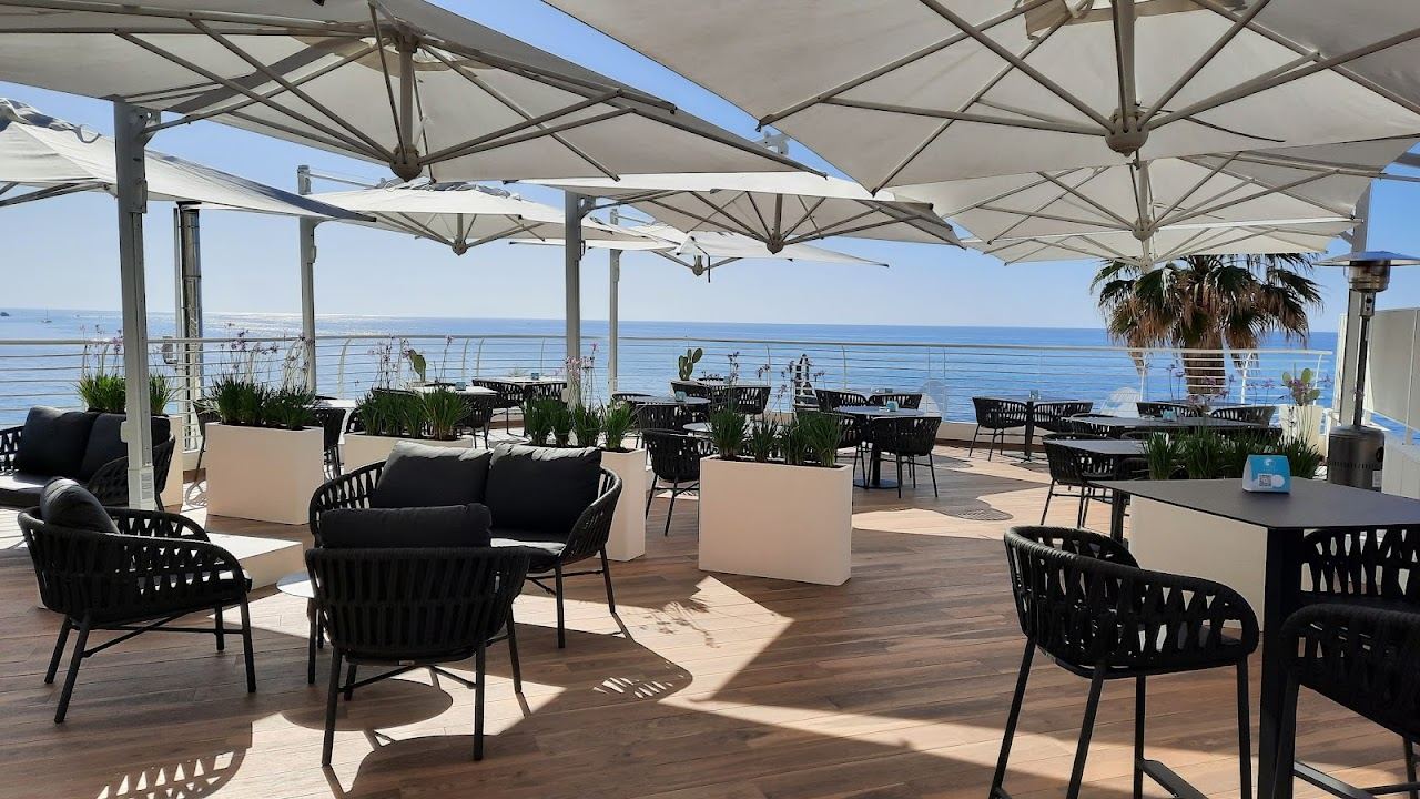 Umbrellas and loungers on the Tropea sand at Sunset Beach Club, with the Tyrrhenian Sea beyond
