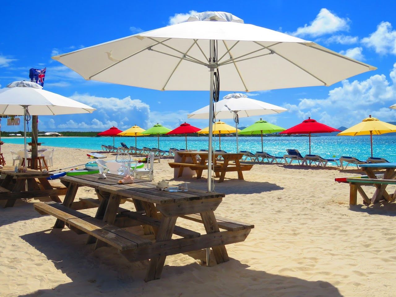 The brightly painted Sunshine Shack beach bar on the sand at Rendezvous Bay