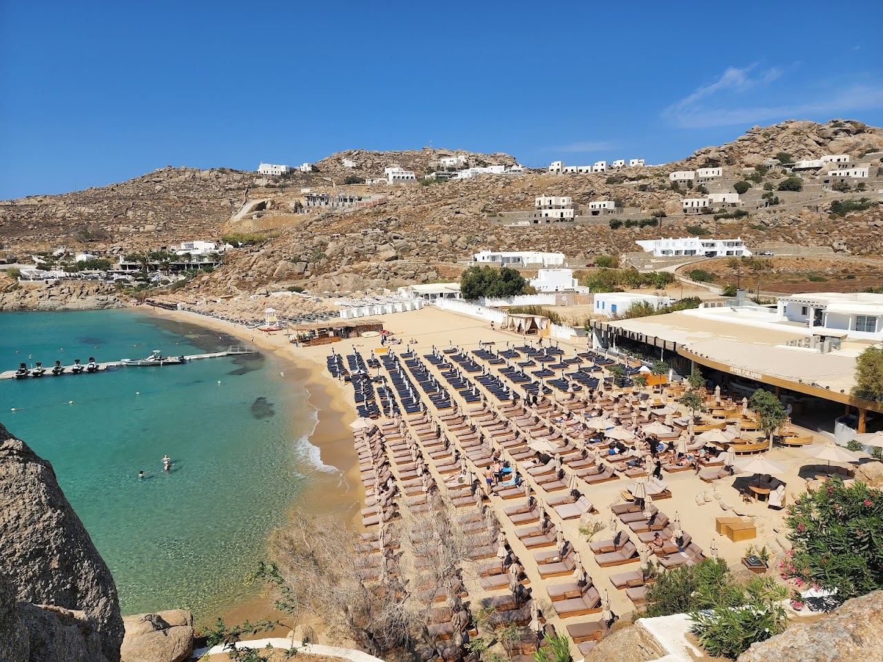 Sunbeds and clear blue water at Super Paradise Beach Club on the south coast of Mykonos