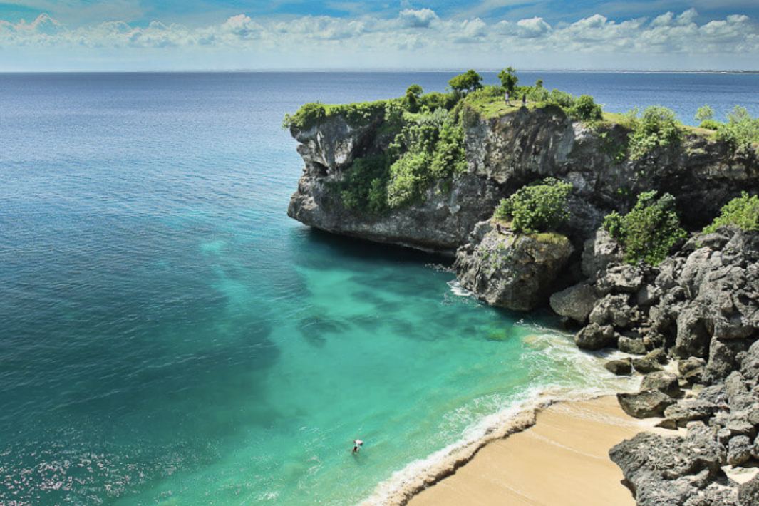 The cliff and long left reef wave at Balangan Beach in Bali