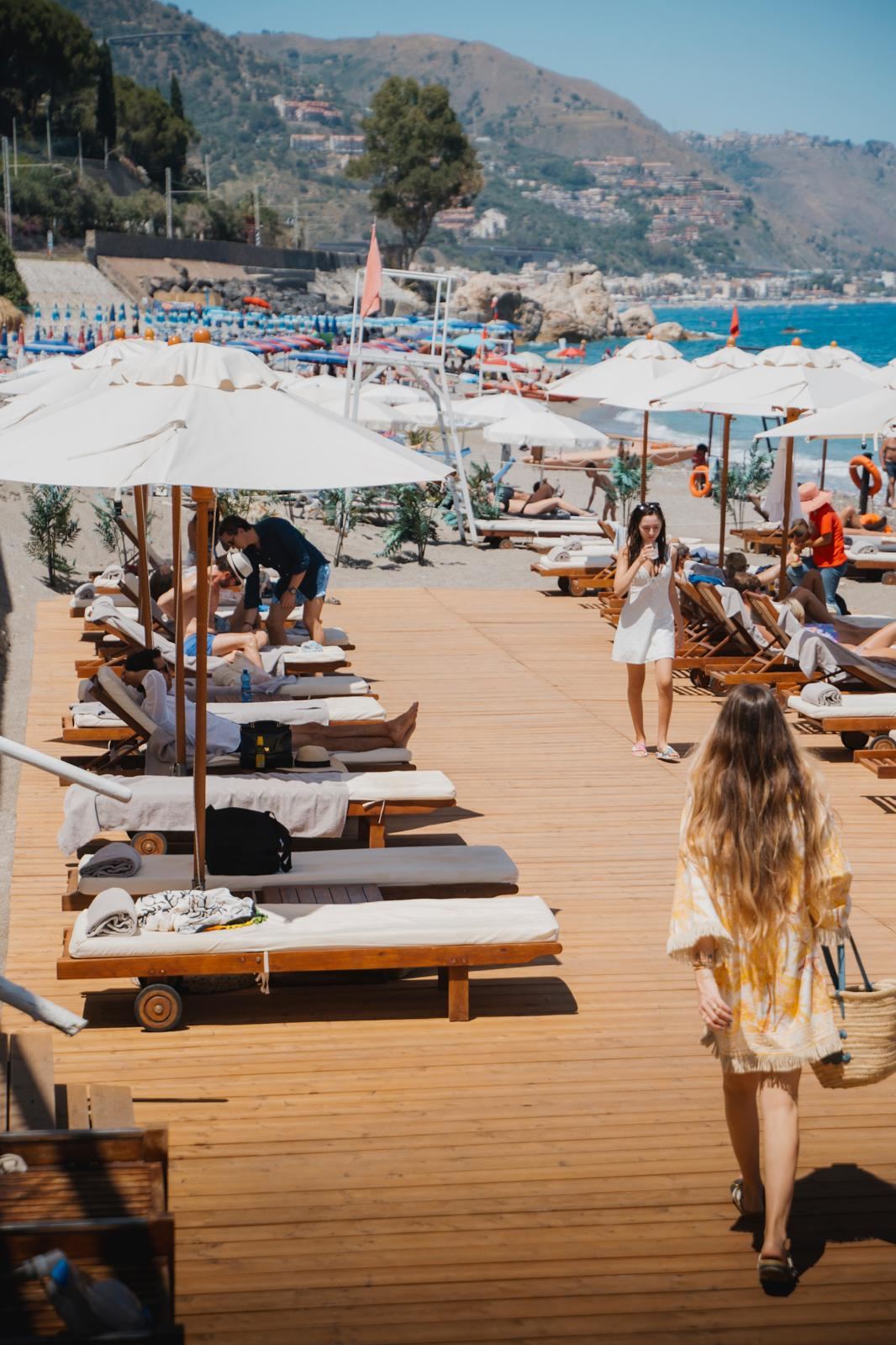 Sea facing terrace and loungers at Tao Beach Club above the Ionian near Taormina