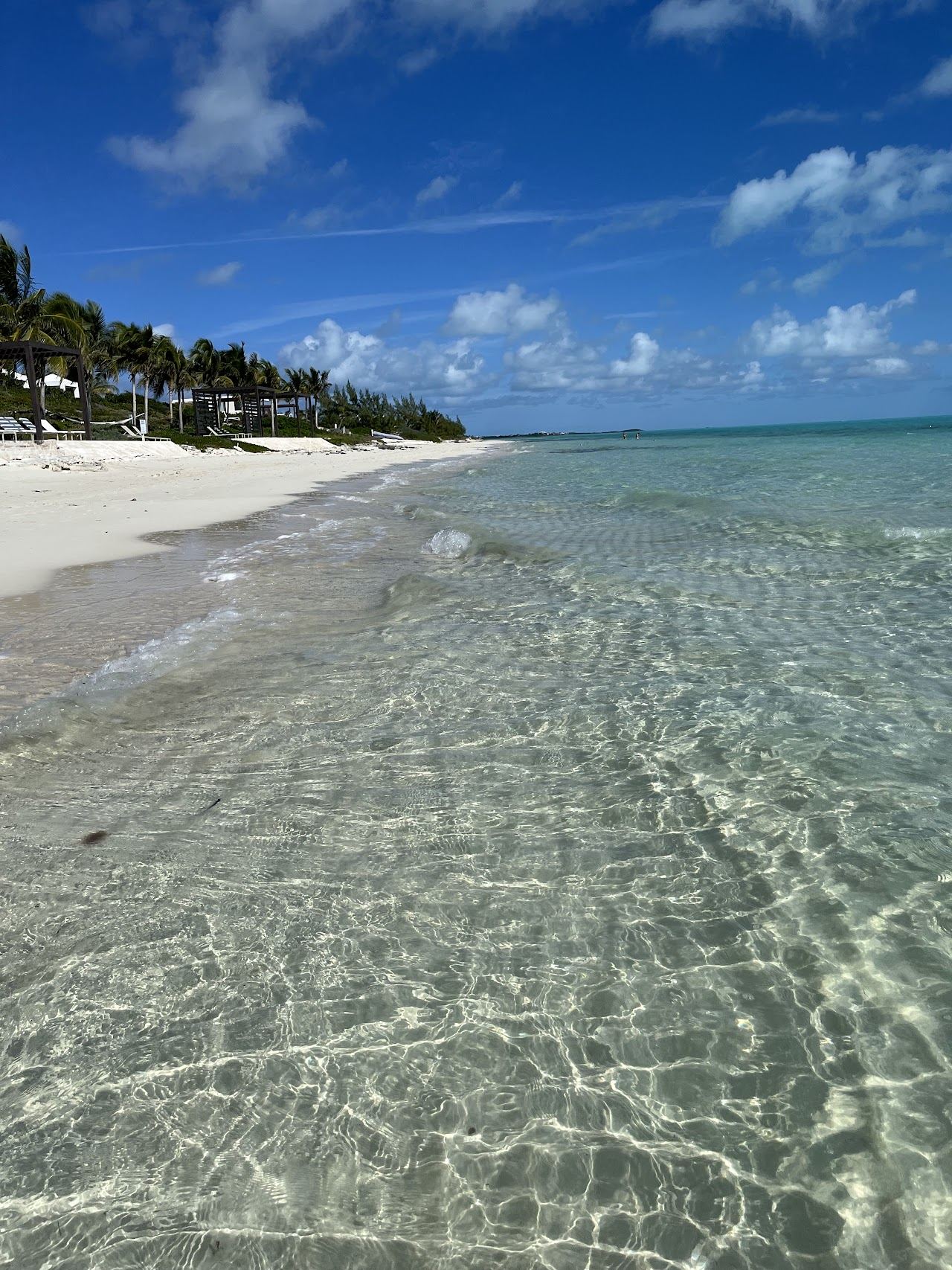 Bright blue shallow water and pale sand on a watersports beach in Turks and Caicos