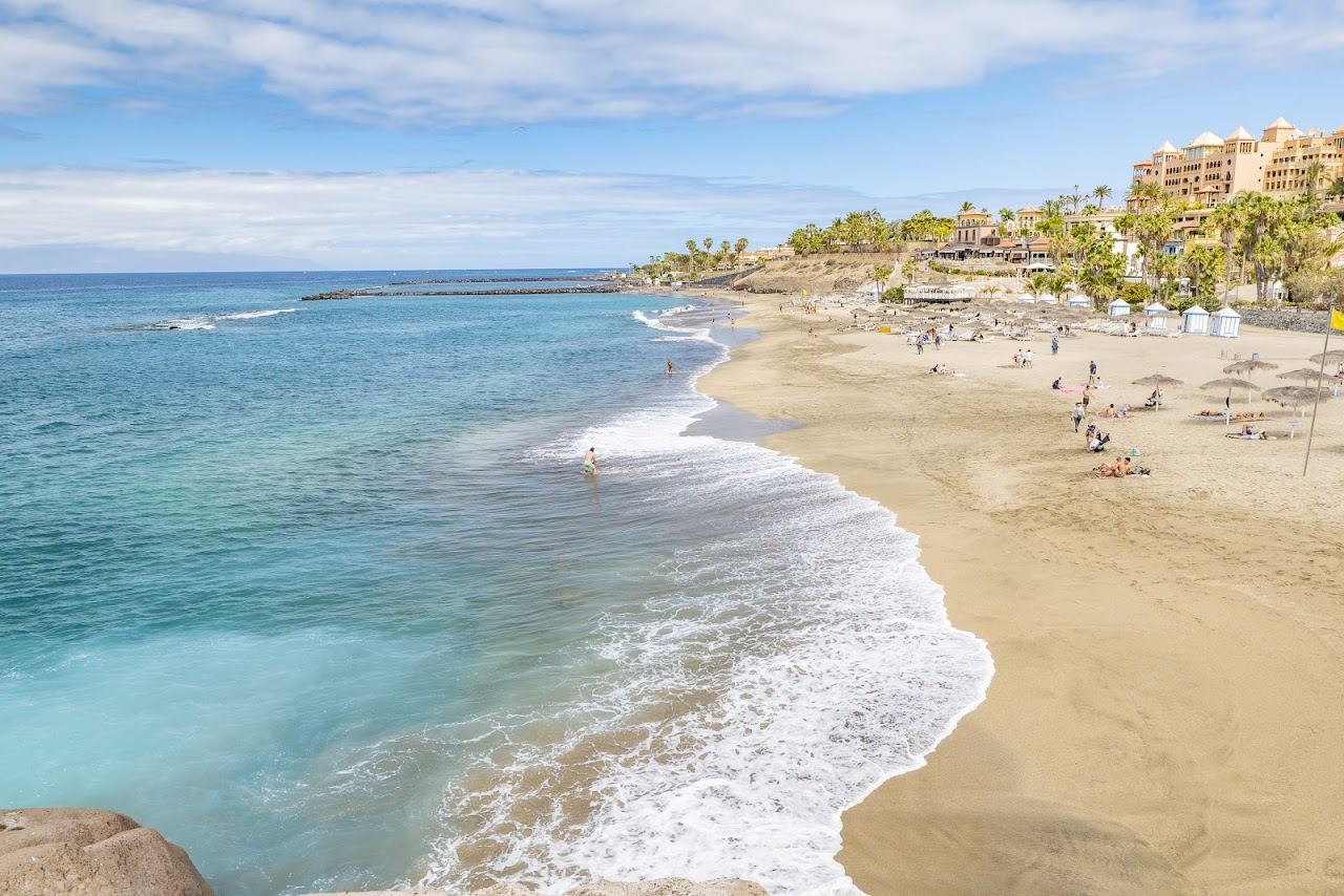 Calm clear water and soft golden sand on a sheltered Tenerife beach