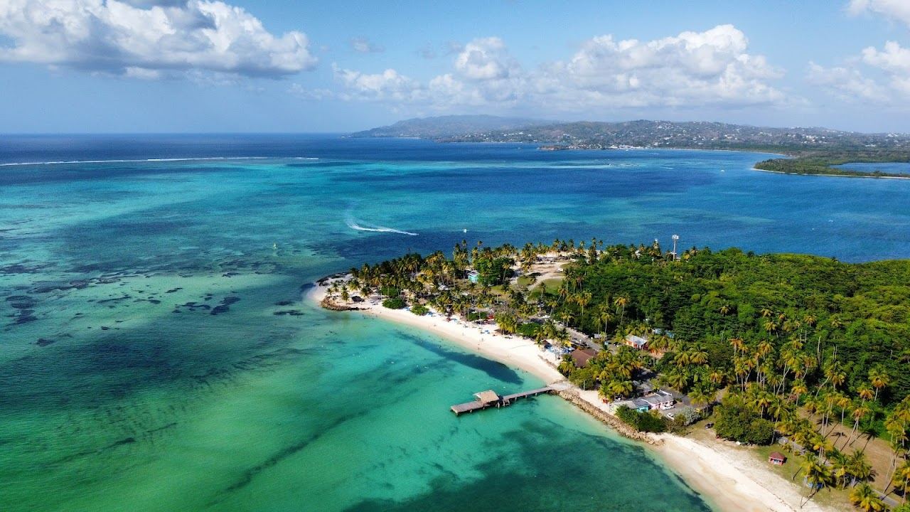 The thatched jetty and calm turquoise lagoon at Pigeon Point in Tobago