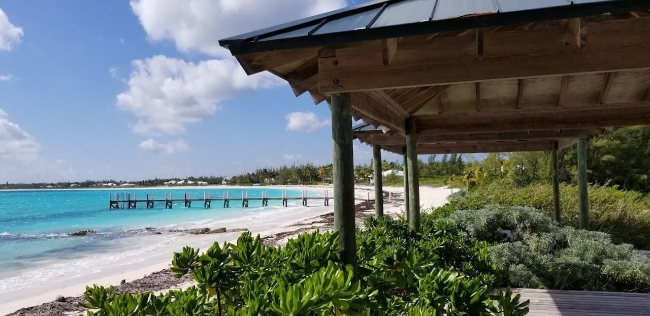 Long curving crescent of white sand and calm turquoise water at Treasure Cay Beach on Great Abaco Bahamas