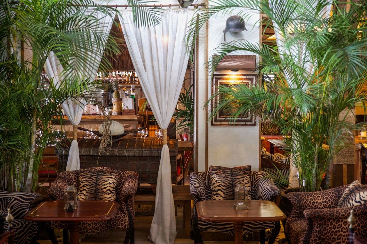 Sunbeds and the beachfront dining terrace of Trocadero Arena on Rio Real beach in Marbella