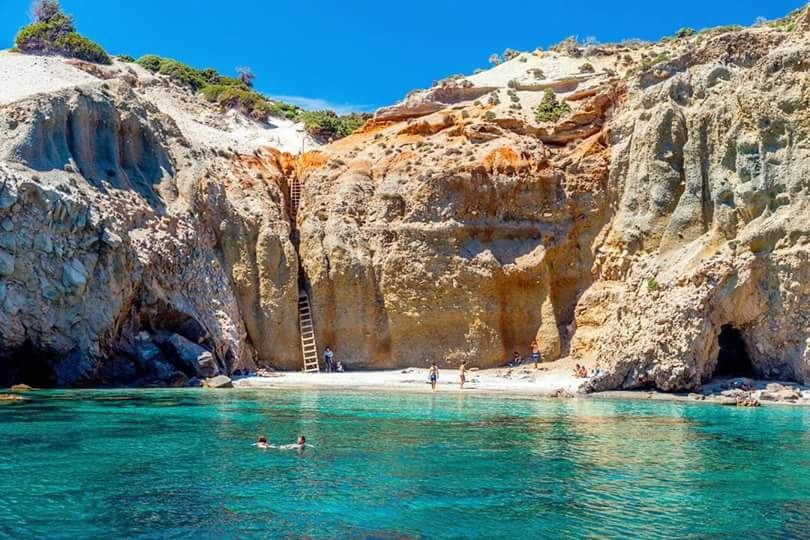 The tiny turquoise cove of Tsigrado framed by tall cliffs reached by a narrow passage on the south coast of Milos