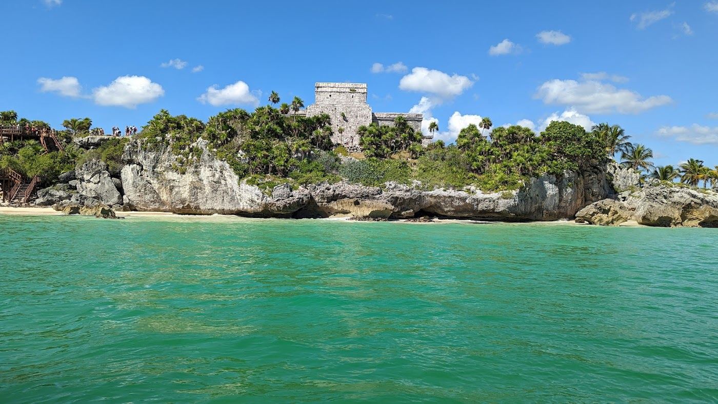 The free public sand and turquoise Caribbean water at Playa Pescadores near the town end of the Tulum beach road
