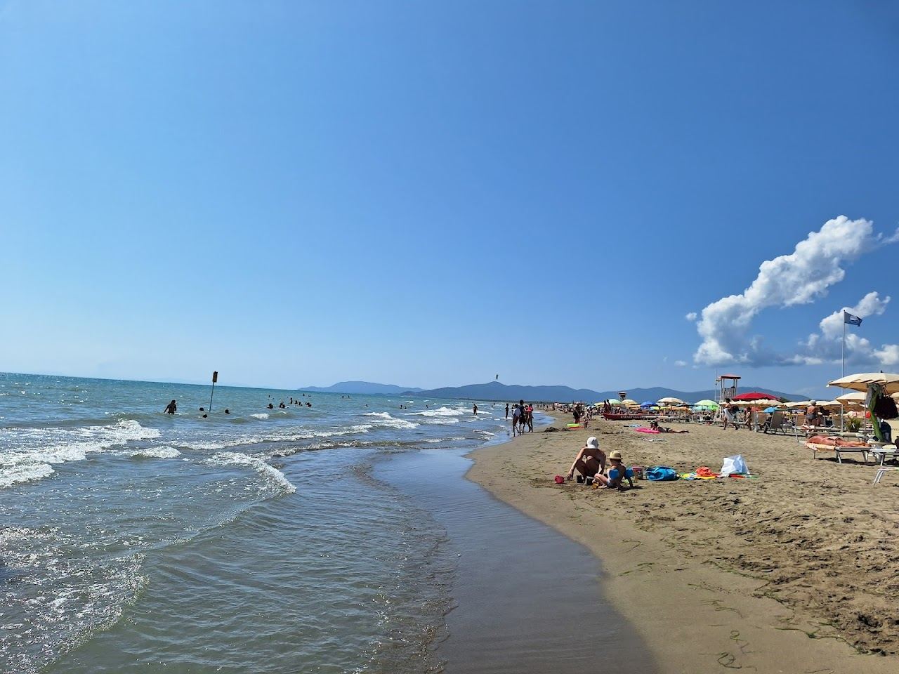 Wide shallow family sand backed by pine forest at Marina di Grosseto on the Maremma coast of Tuscany