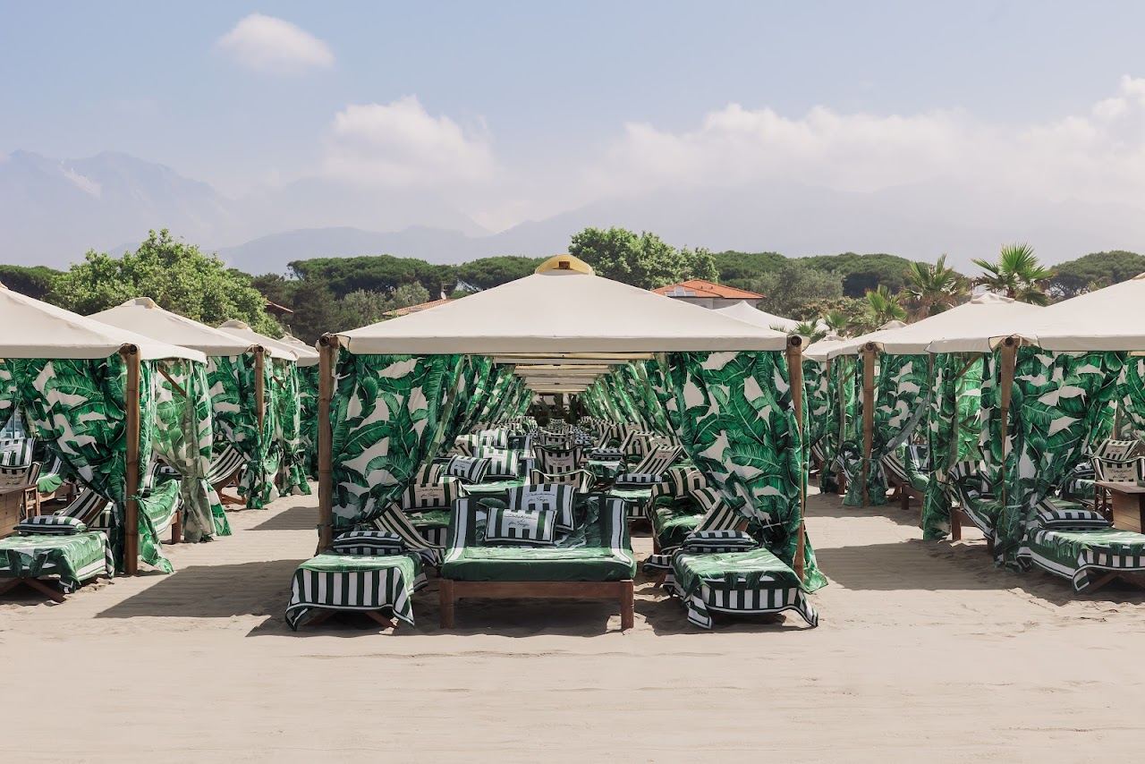 Day beds and white canopies on the sand at Twiga beach club in Marina di Pietrasanta