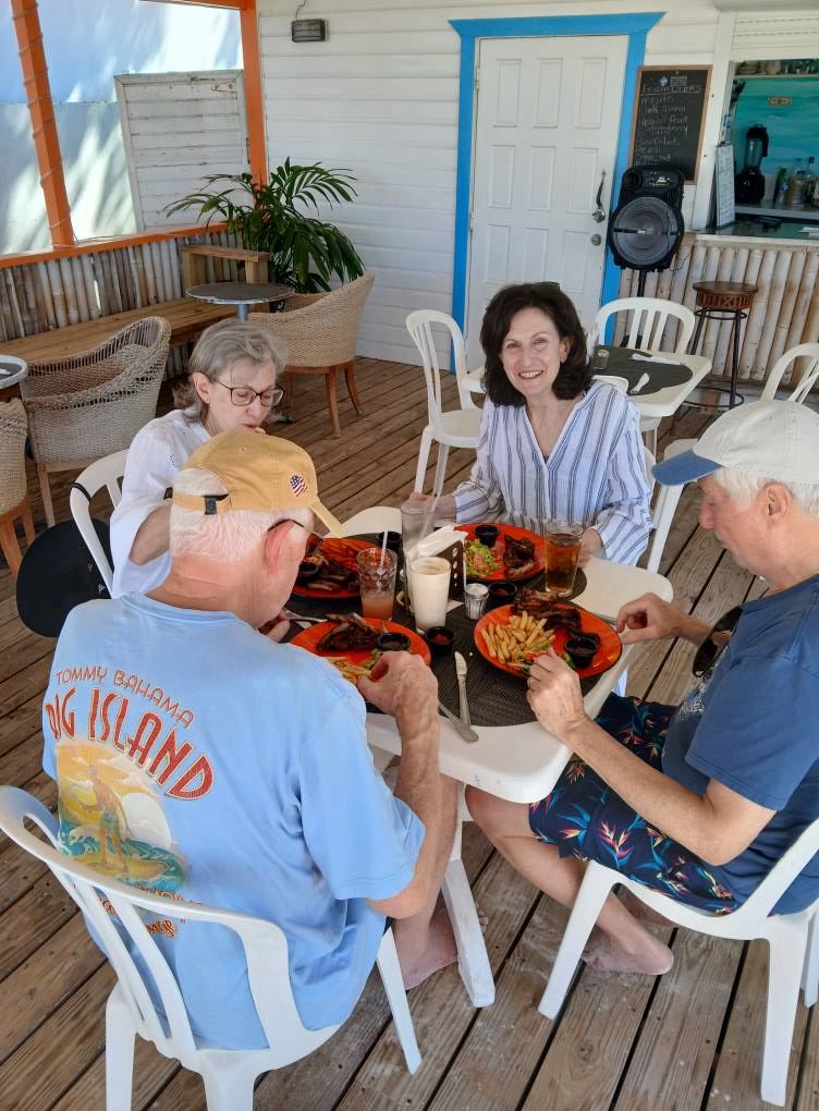 Tables and umbrellas at Uncle Ernie's beach bar on the sand at Shoal Bay East