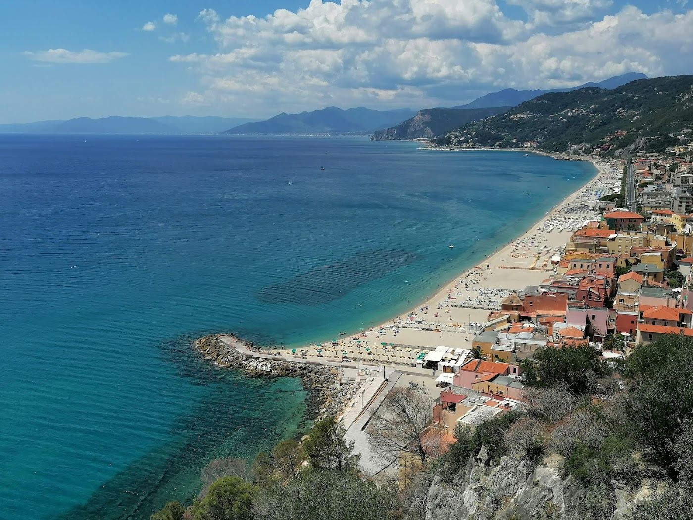 The sandy turquoise bay of Varigotti below pastel houses in Liguria