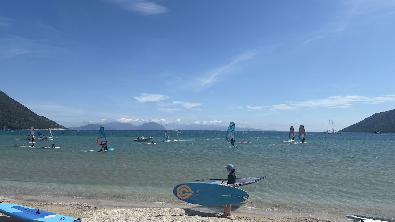 Windsurf sails and turquoise water across the long shallow bay of Vasiliki on the south coast of Lefkada