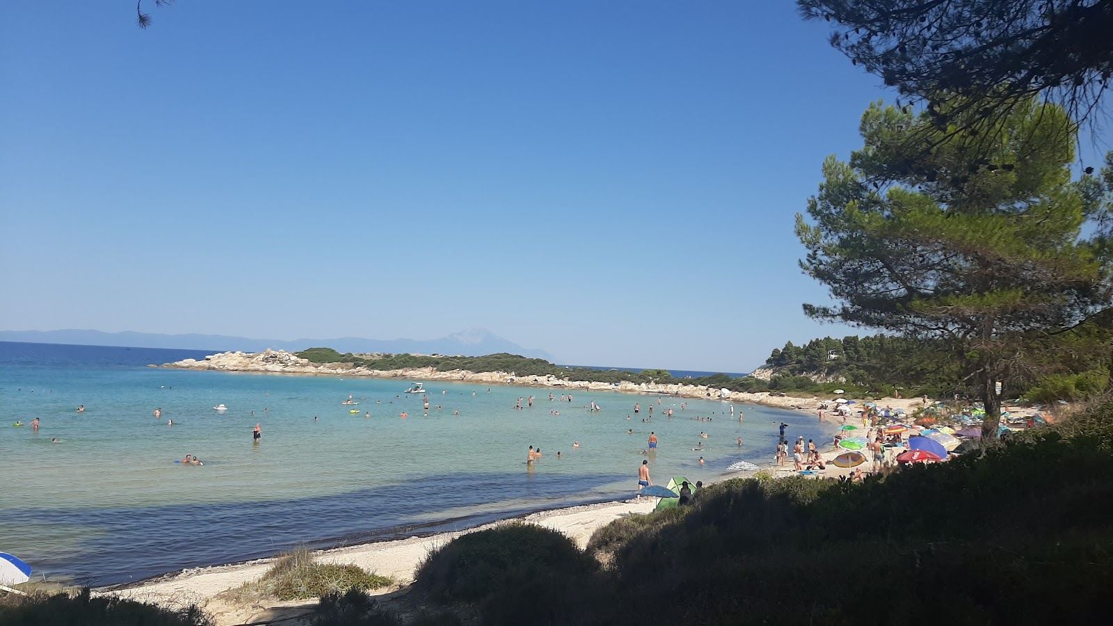 Shallow clear water and small pine covered islands at Vourvourou on Sithonia in Halkidiki