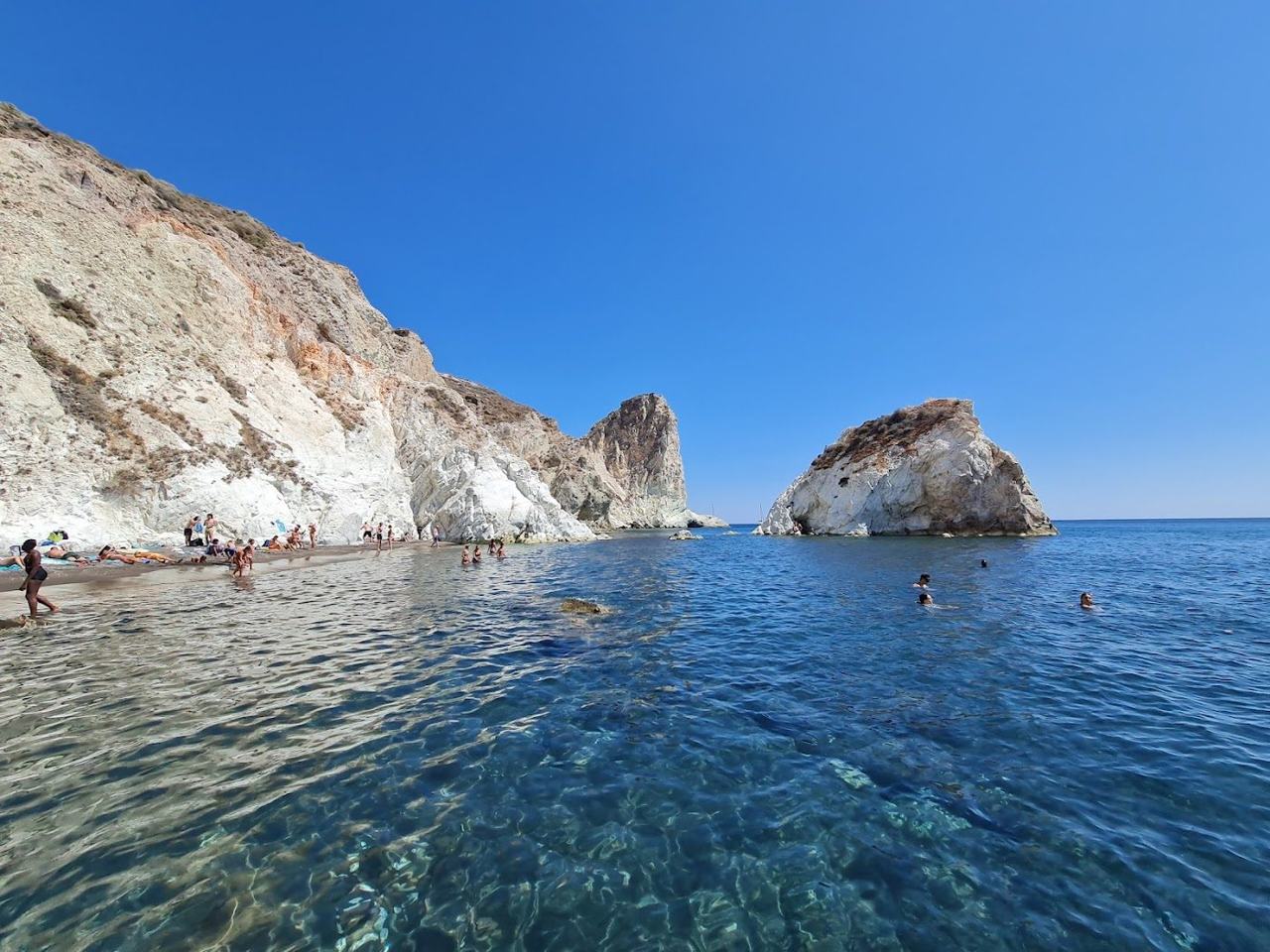 The pale white volcanic cliffs above the secluded pebble cove of White Beach near Akrotiri on Santorini