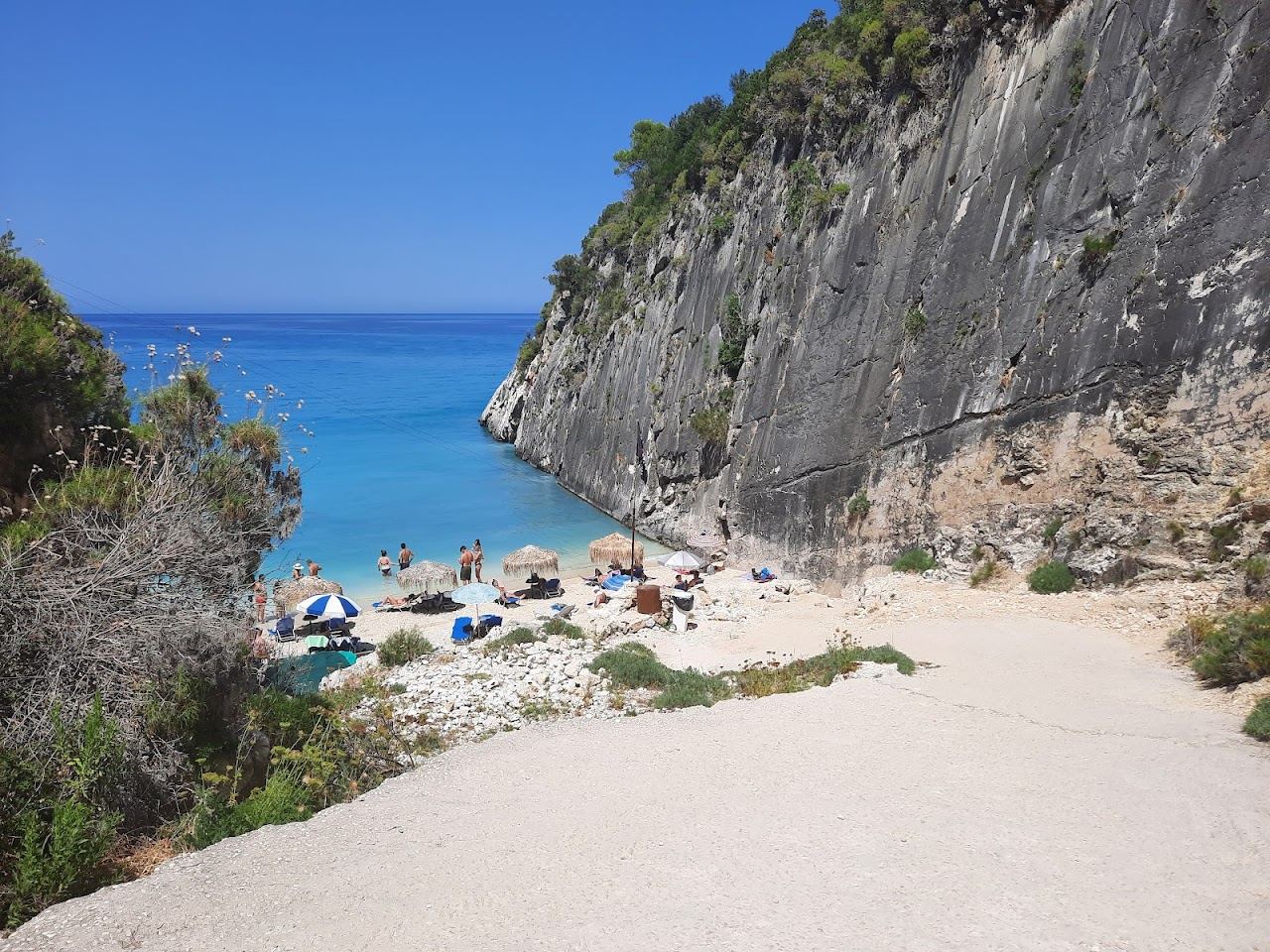 The small pebble cove and clear cool water of Xigia sulphur beach framed by steep cliffs on the north coast of Zakynthos