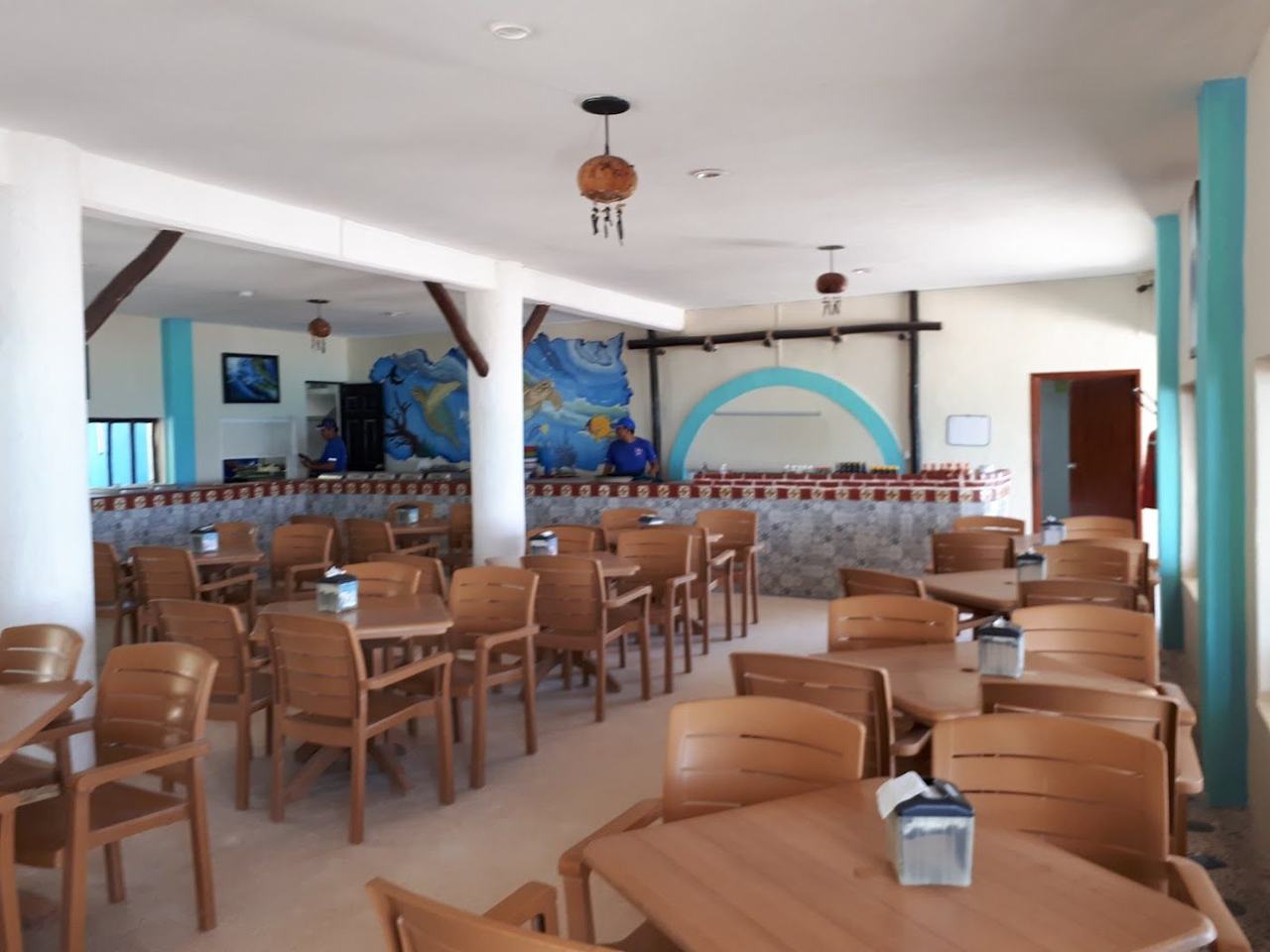 Soft sand and calm clear water at a beach club on Xpu Ha