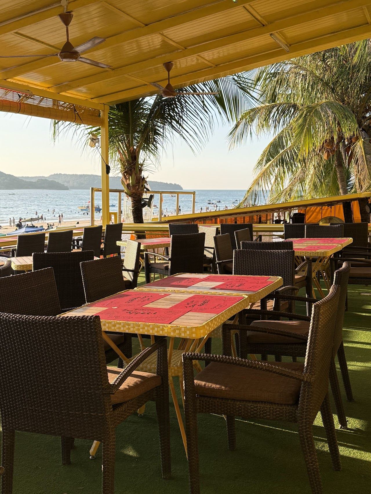Yellow themed beachfront seating and bar at Yellow Beach Cafe on Pantai Cenang, Langkawi